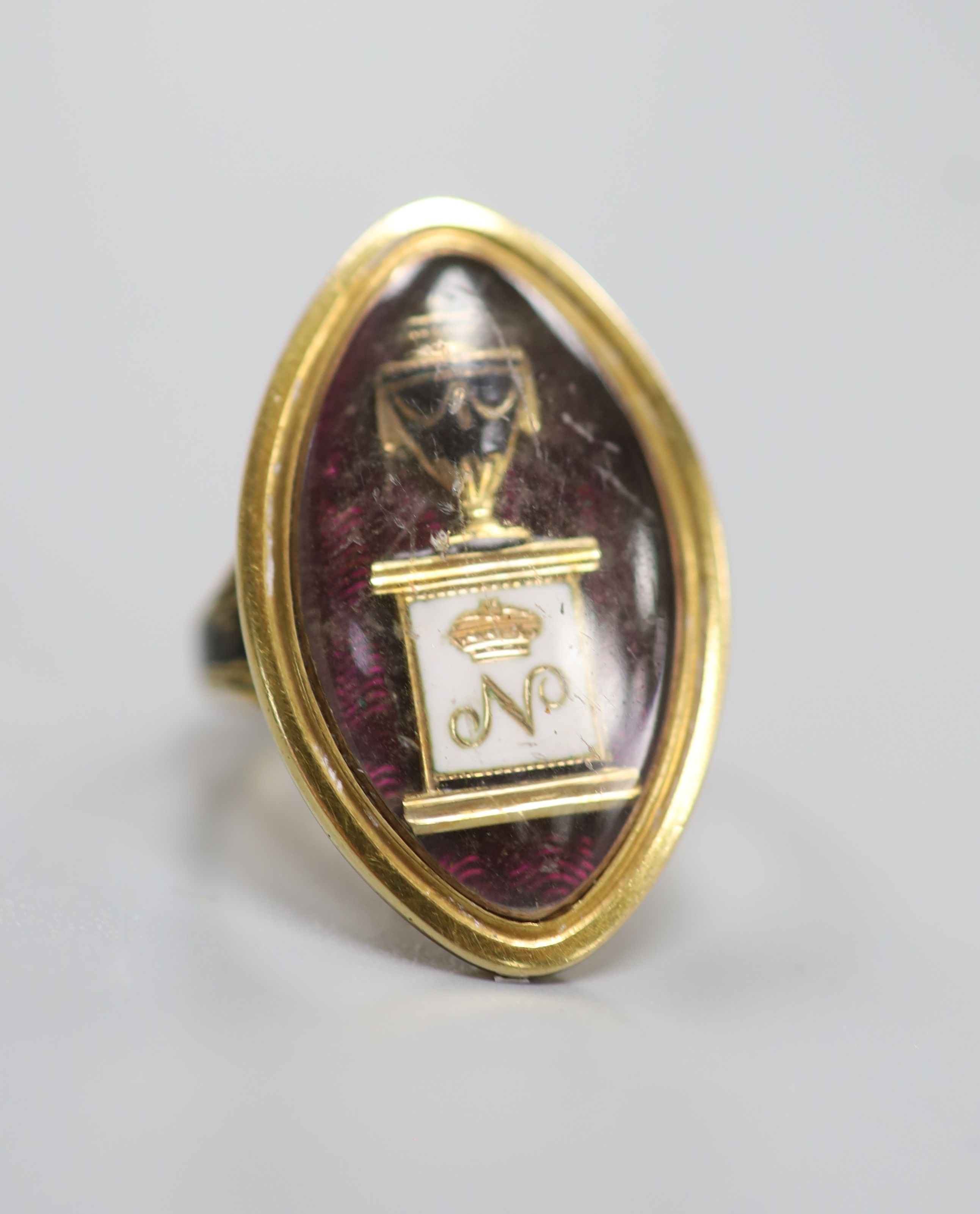 A George III yellow metal and three colour enamel navette shaped mourning ring, with Ducal coronet above 'N' on a pedestal with urn above, the shank with black enamel inscription which reads 'HU. DUX NORTHbr. OB 6 Jun. 1